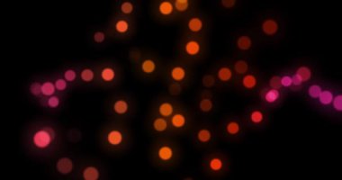 Parlayan parlak hareketli bulanık bokeh parçacıklarının soyut arkaplanı.