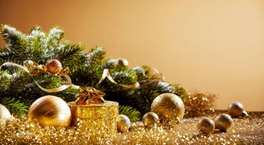 Christmas fir with golden decorations and tinsel in a festive still life with copy space for your seasonal greeting clipart