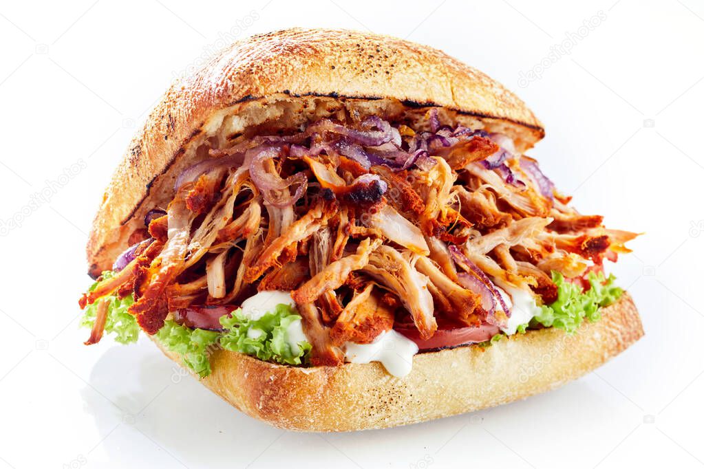 Roasted meat sandwich with vegetables and mayonnaise isolated against white background
