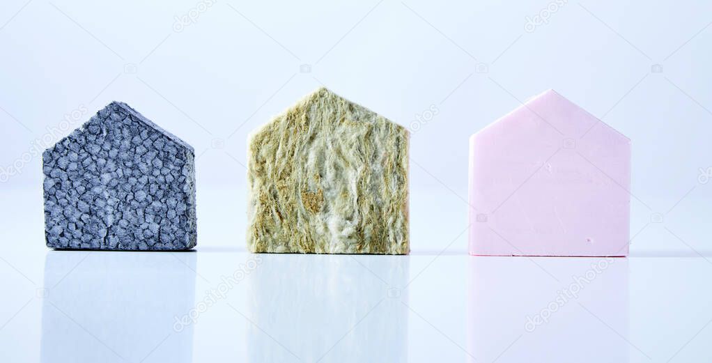 Blue, green and pink textured house shapes isolated on a white background.