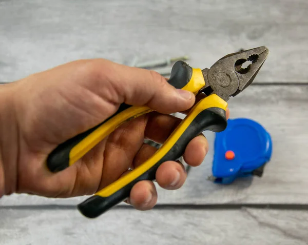 Locksmith iron pliers in the hand of a man. — Stock Photo, Image