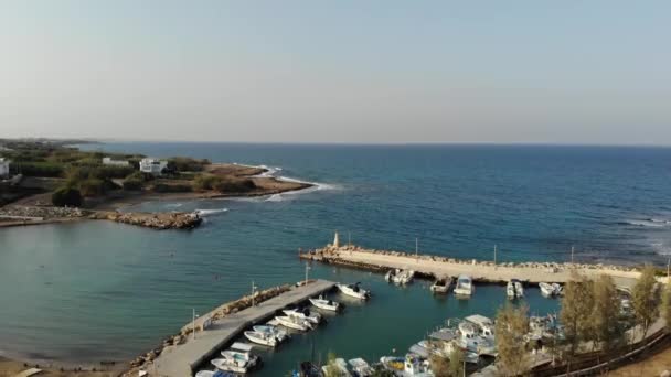 4k Aerial view to the marina with small boats. Blue sea with pier. — Stock Video