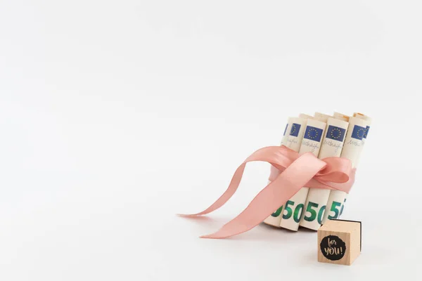 50 euros en rollos atados con cinta rosa y cubo con palabras para ti en él. — Foto de Stock