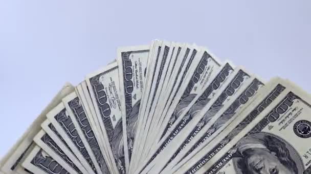 Ventilador 4k de notas de 100 dólares acenando em um fundo branco. — Vídeo de Stock
