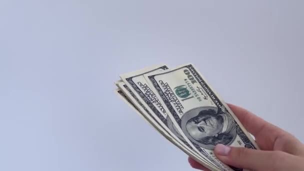 4k vrouwelijke handen houden US dollars op een witte achtergrond. — Stockvideo