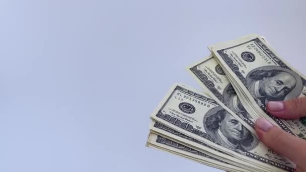 4k vrouwelijke handen houden US dollars op een witte achtergrond. — Stockvideo