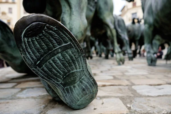 Pamplona bull run monument with building behind. Sole in foreground. Spain holidays.