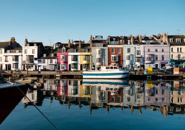 Weymouth's harbor in a beautiful morning. Colorful houses. Tourism in England.