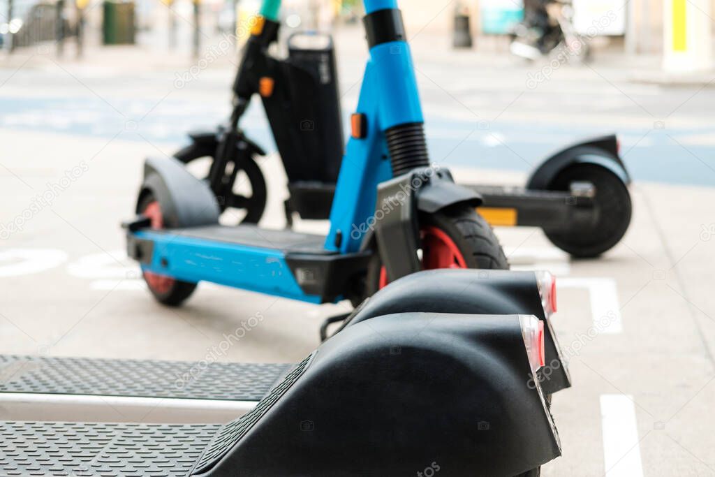 E-scooters parked in the sidewalk in London. Ecological Concept.