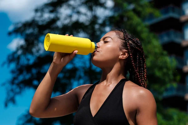 Attractive Young Woman Drinking Yellow Bottle She Wearing Black Top — Stock Photo, Image