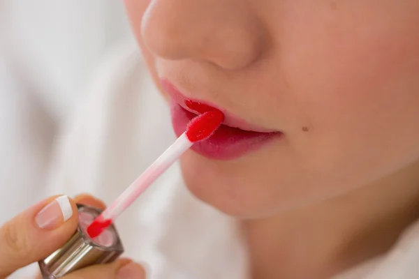 Sensual young woman applying cosmetics on her lips — Stock Photo, Image