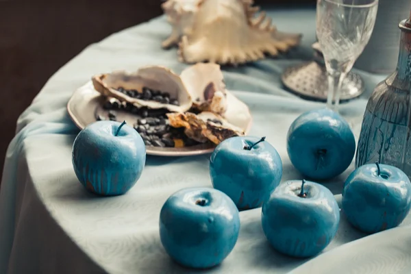 Pięknie urządzone tabeli z muszli i niebieskie jabłka — Zdjęcie stockowe