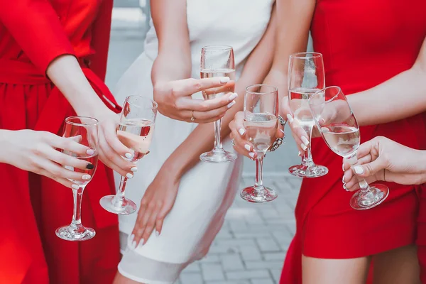 Belle ragazze in abiti rossi stanno celebrando un addio al nubilato e bere champagne — Foto Stock