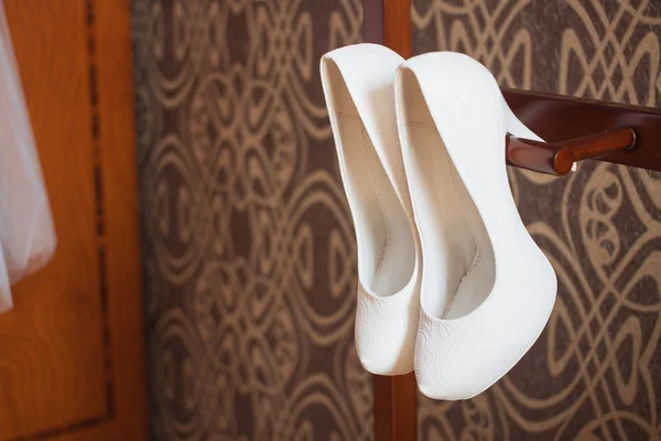 Cute stylish beige high heels with a bow on the background room, glamor, fashion, wedding