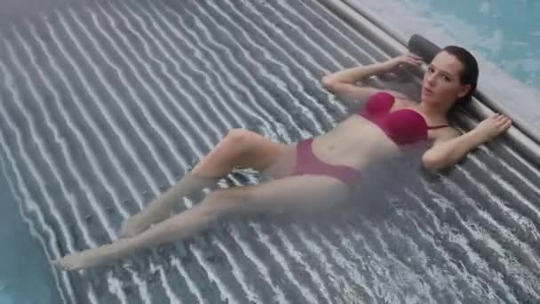 Uwodzicielska kobieta odpoczywająca w basenie — Wideo stockowe