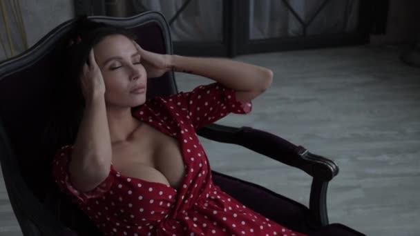 迷人的年轻女子穿着女装躺在扶手椅上 — 图库视频影像