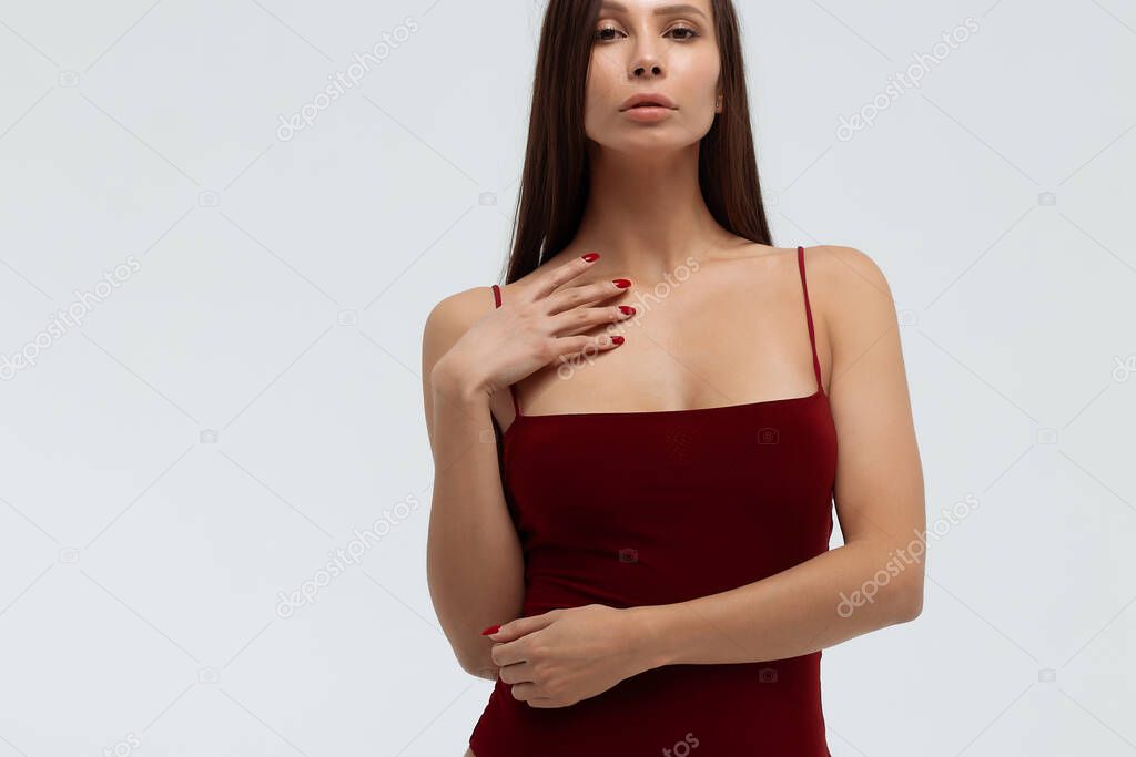Seductive woman in bodysuit in studio