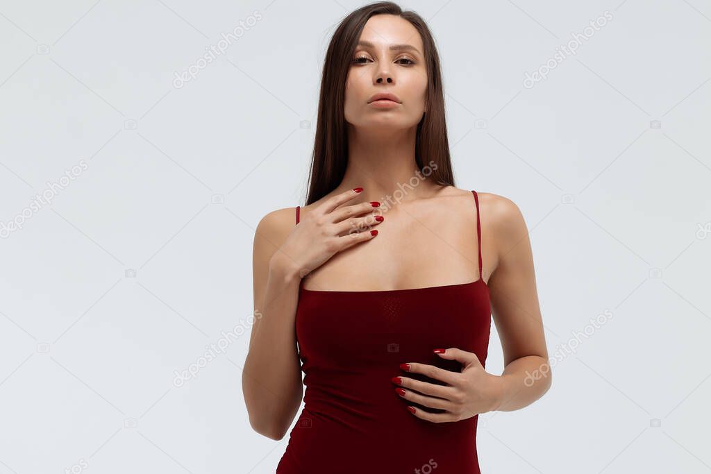 Seductive woman in bodysuit in studio