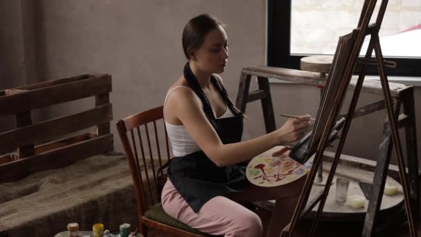 Calme femme peinture dans la lumière home studio — Video