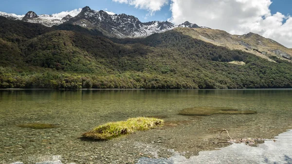Kristallklar sjö med skog och berg i bakgrunden, skjuten vid Mavora sjöar, Nya Zeeland — Stockfoto