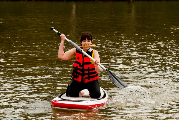 A girl swimming on a boat Latvian, Limbazhi competition girls on swimming boards. — Stock Photo, Image