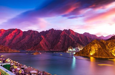 Beuatiful view of Hatta Lake and Hajar Mountain in the Emirate of Dubai, UAE at sunset