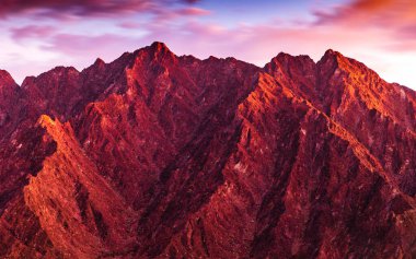 Scenic view of Hatta Hajar Mountain in the Emirate of Dubai, UAE at sunset.