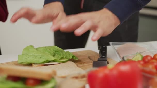 Man Woman Preparing Sandwich Putting Salad Leaf Cheese Bread — Stock videók