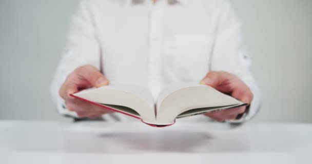 Person Holding Open Book — Stockvideo