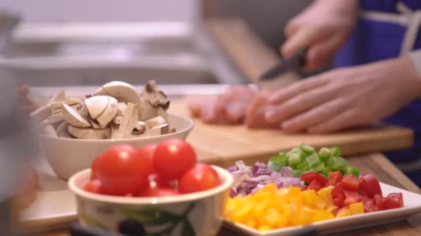 Woman Slicing Chicken Breast Table Vegetables — Stock Video