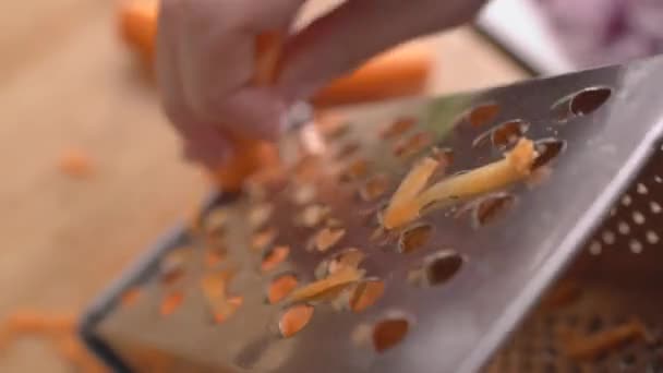 Woman Shredding Carrots Grater — Stock Video