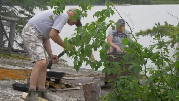 Człowiek Rąbiący Drewno Nad Brzegiem Jeziora — Wideo stockowe