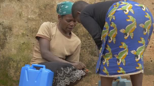 Women Filling Carrying Water Canisters — Stock Video