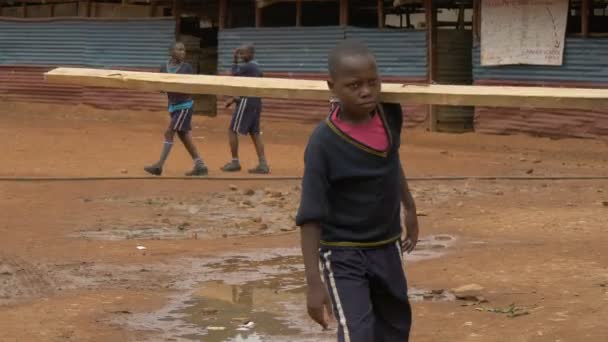 Afrikalı Bir Çocuk Bir Odun Parçası Taşıyor — Stok video
