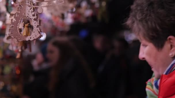 Woman Admiring Christmas Wooden Souvenirs — Stock Video