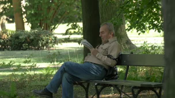 老年人在公园里看报纸 — 图库视频影像