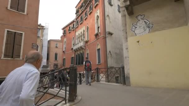 People Crossing Bridge Old Buildings — Stock Video