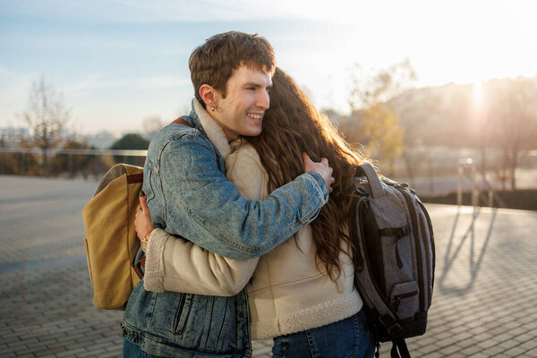 Happy students hugging at university campus during reunion