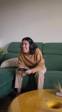 Video oyunları oynarken gülümseyen genç kadın