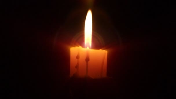 One candle in dark Stock Video