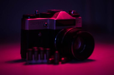 Karanlık bir odada, aydınlık ve fişekli eski bir kamera