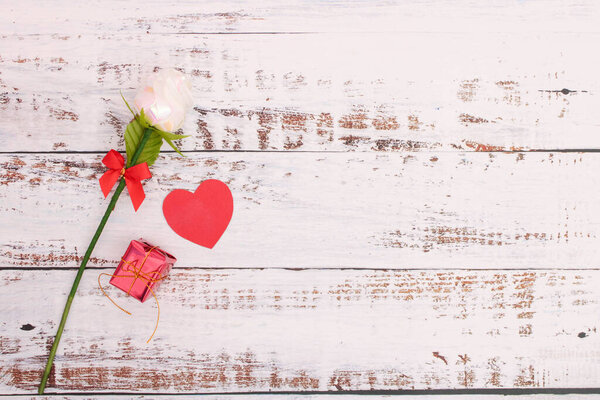 Paper hearts with red boxes and roses on white wood floors for design and in Valentines Day