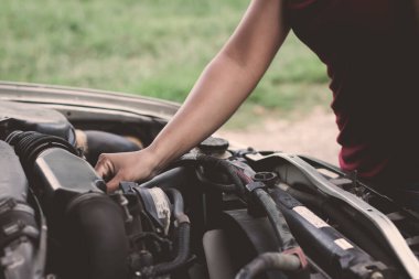 Arabanın motorunu kontrol eden kız.