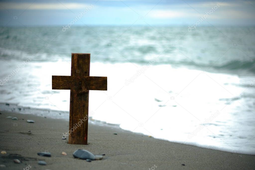 Holy cross on beach