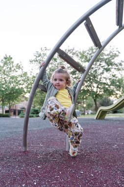 Parktaki bir barda sallanan sarışın bir kızın ön görüntüsü..