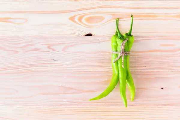 Green peppers placed on wood. — Stock Photo, Image