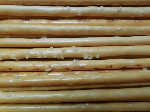 Crispy thin sticks (bread product) with coarse-grained salt.