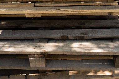 old wooden pallets. garbage removal. old wooden pallets for recycling. Many pallets stacked in stock, warehouse pallets, old wooden pallets