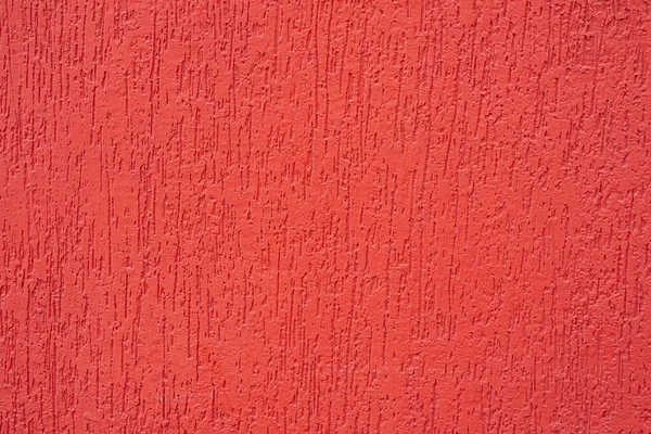 Red walls, textures and backgrounds. beautiful texture of red brush painted on cement wall, with visible texture for design, close up image of painted wall