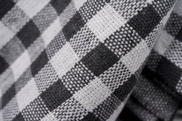 Black and white checkered clothes isolated. Picnic towel, selective focus, macro view. Lined black and white dinner clothes